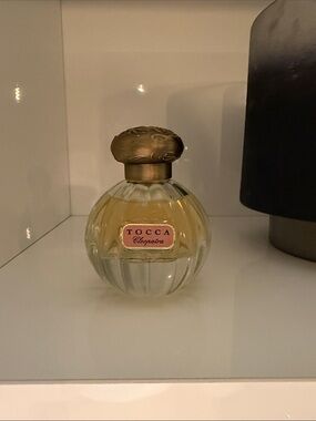 Tocca Perfume Bottle with Pink Accents and Amber Liquid